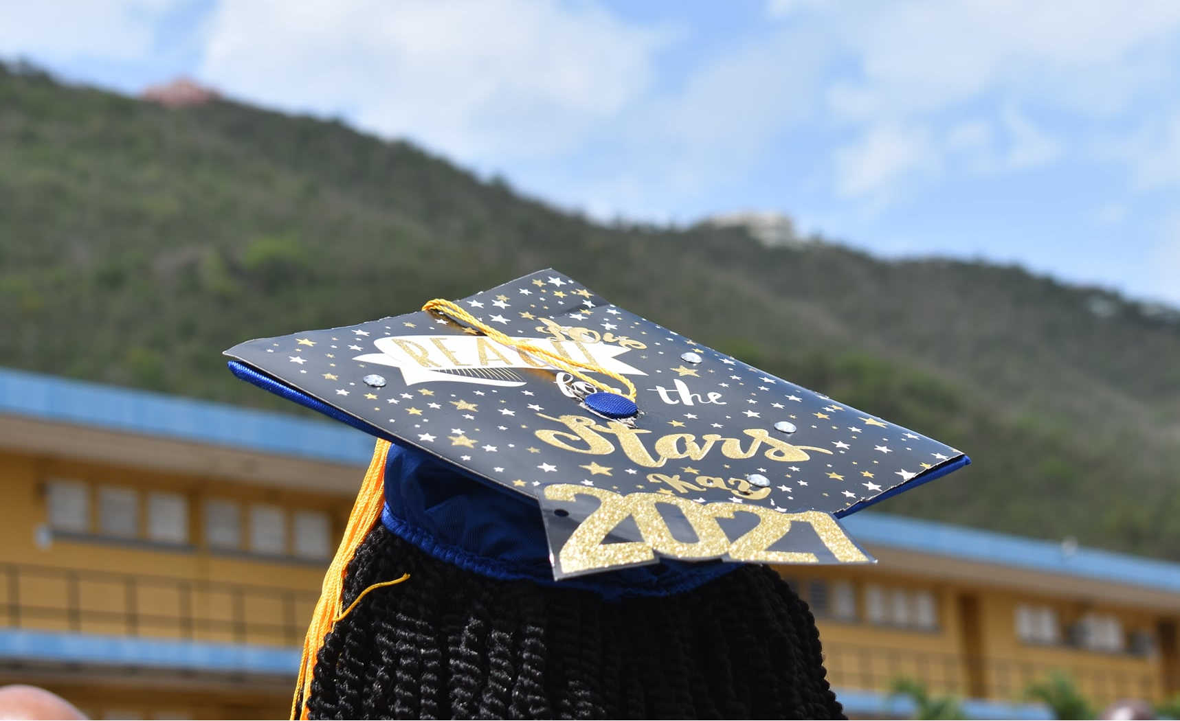 Charlotte Amalie High School student with cap.