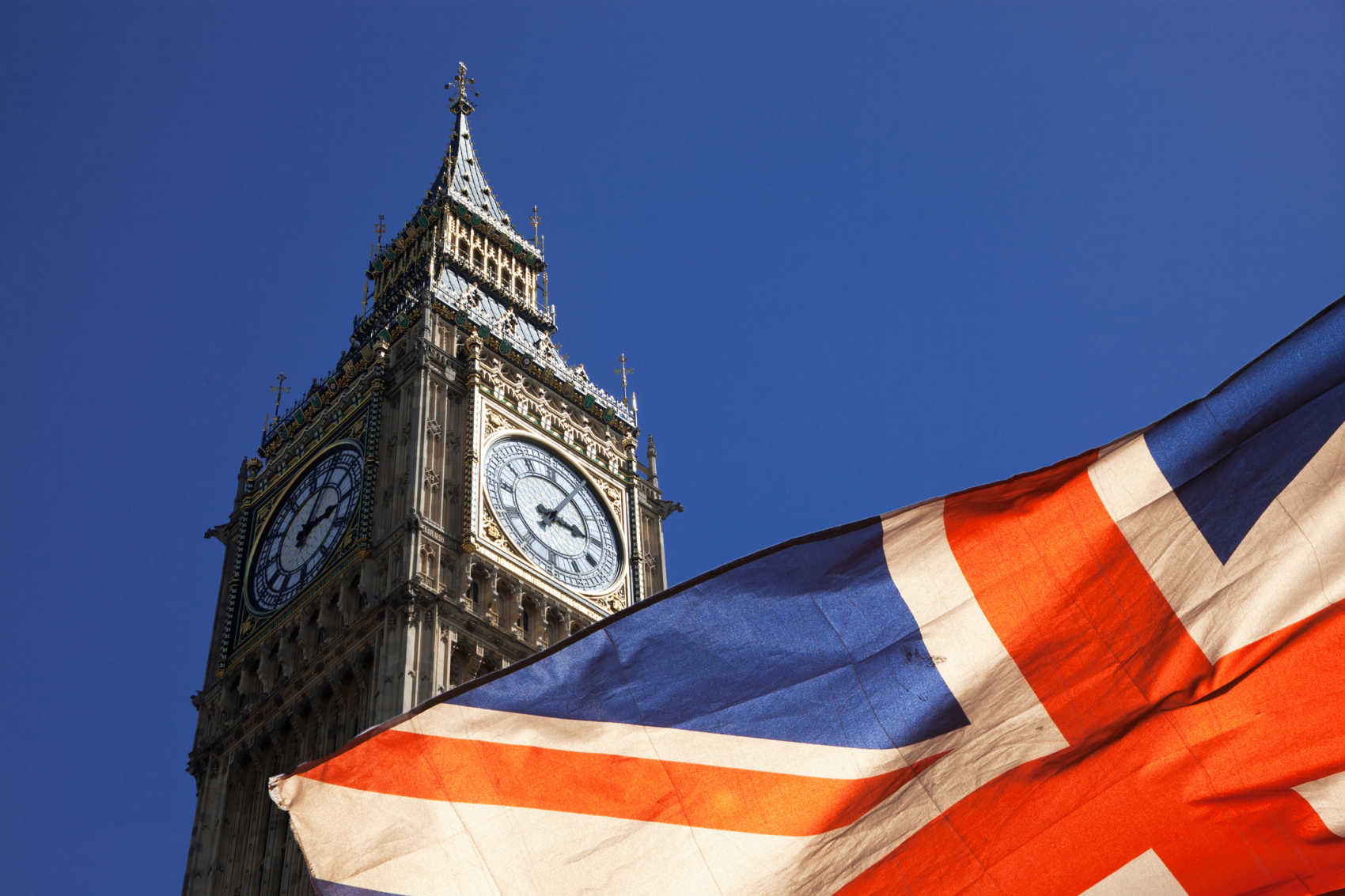 Double exposure of flag and Westminster Palace with Big Ben clock in the UK.
