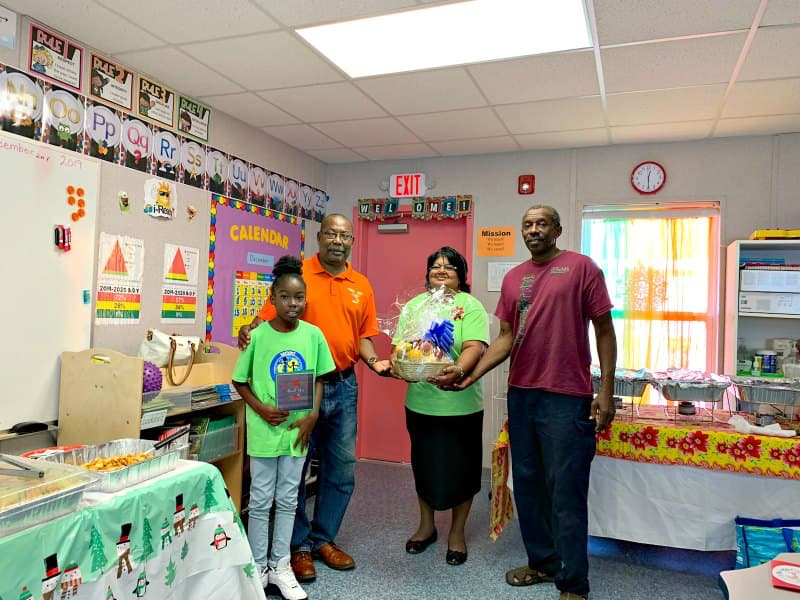 Early Act President De'Jahnique Morris, Rotarian Sinclair Wilkinson, Early Act Advisor, Librarian Merle Vanterpool and Chess Coach Kelvin Malone.