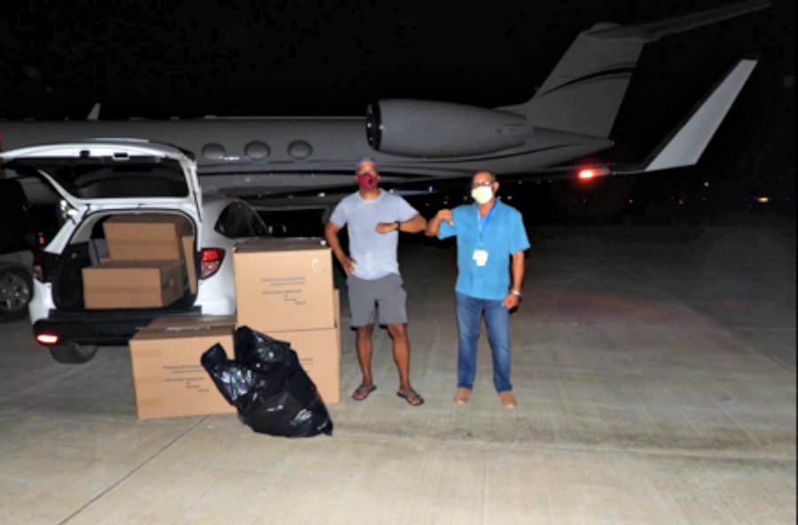 William “Bill: Perkins and Dr. Clayton Wheatley, Director of the Emergency Department at the Roy Lester Schneider Regional Medical Center, load shipment of KN95 respiratory masks for transport from Cyril E. King Airport in St. Thomas to the hospital.