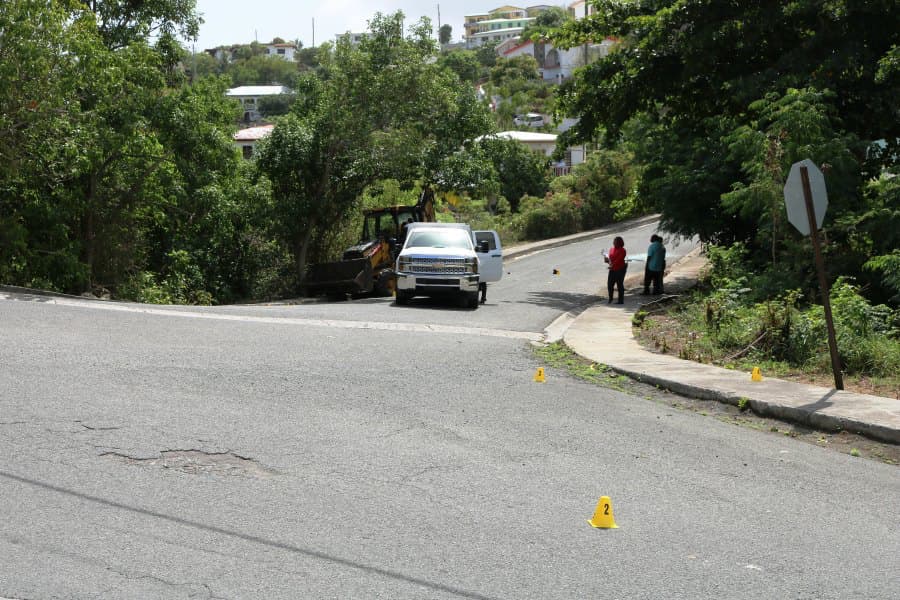 Police Detectives and employees of the Medical Examiners office at the scene of a shooting, where 29-year-old Rique Ashby and 14-year-old Aaron Ashby succumbed to gunshot wounds.
