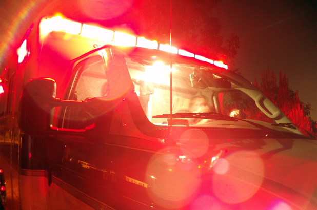 An Ambulance with emergency lights flashing