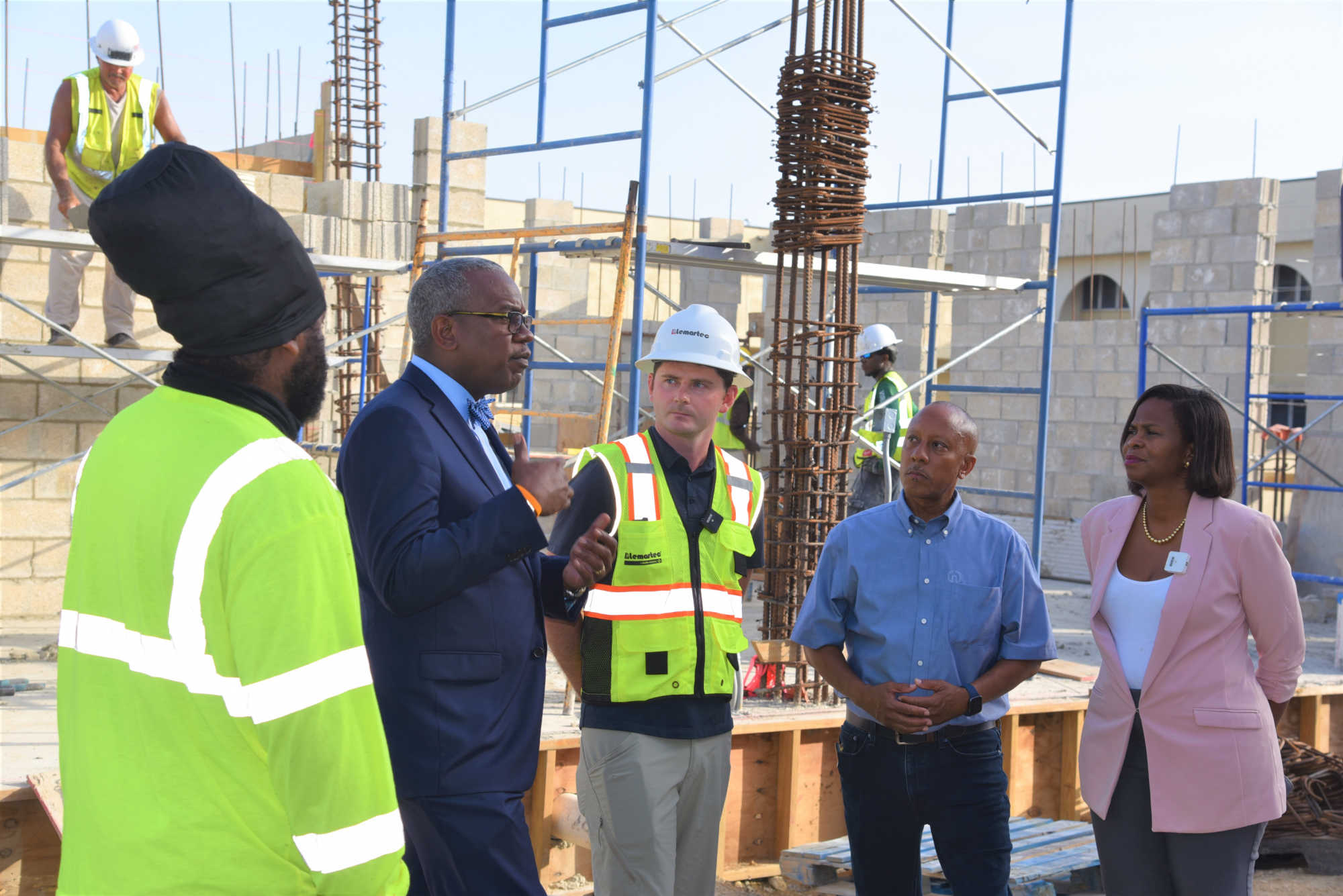 Governor Albert Bryan, center left, with Lemartec employees along with THRT exec. dir. Darryl Smalls, and Office of Disaster Recovery Director Adrienne L. Williams-Octalien, far right on May 18 at the JFL North site.