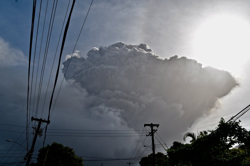 Ash rises into the air as La Soufriere volcano erupts on the eastern Caribbean island of St. Vincent, seen from Chateaubelair, Friday, April 9, 2021.