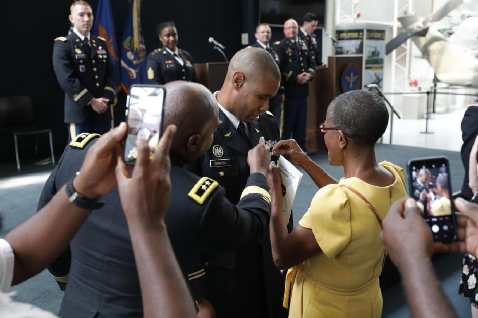 Capt. Elvor J. Narciss enlists the help of his family and Maj. Gen. Kodjo Knox-Limbacker to pin his Army aviation wings as he graduates flight school at the U.S. Army Aviation Museum at Fort Rucker, Alabama, May 5, 2022.