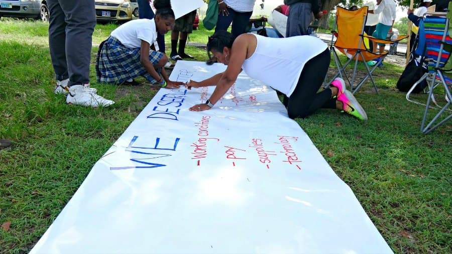 Complex protesters prepare banner during all-day job action.