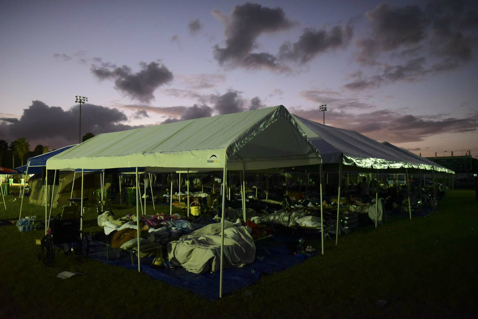 Puerto Ricans sleep in tents outside as the island struggles to regain power and homes have been flattened by multiple earthquakes