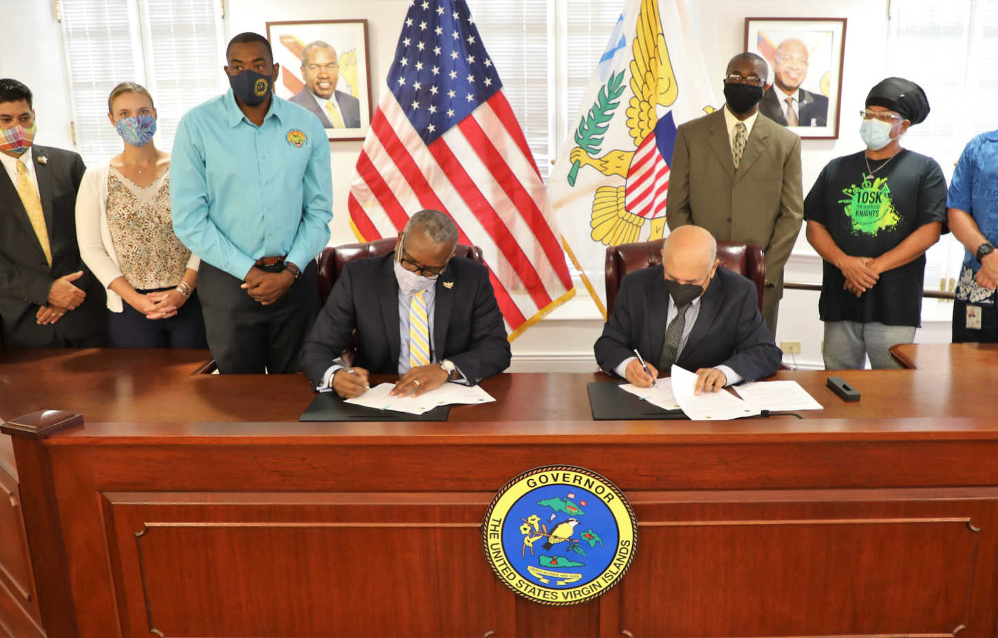 Gov. Albert Bryan Jr. and Jehangir Zakaria, Vice-president of Engineering/Energy for Renaissance Group, sign the agreement for a 2.5-acre donation of land to be used for the construction of a drag racing facility on St. Croix.