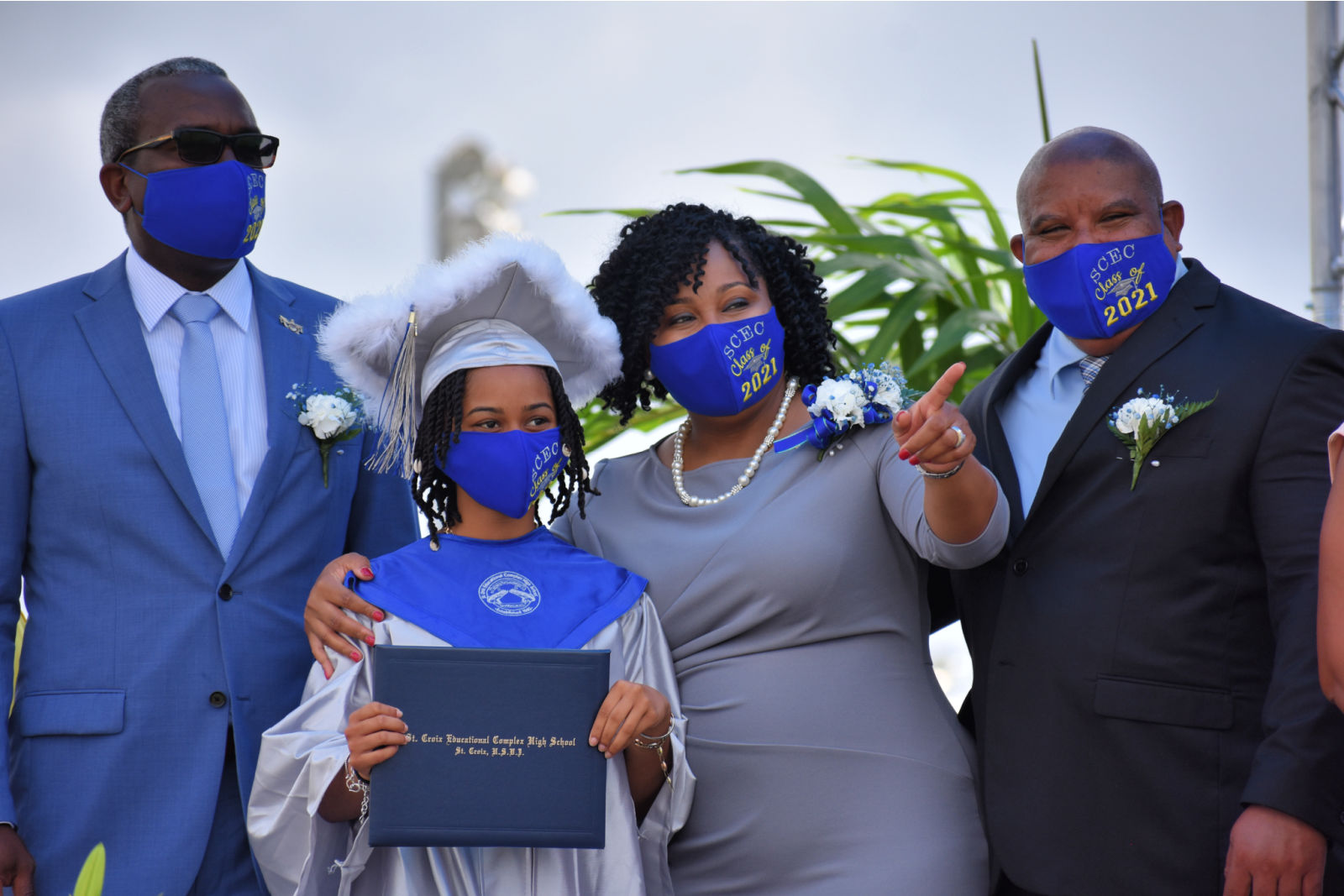 From left to right: Governor Albert Bryan, a graduate, Education Commissioner Racquel Berry-Benjamin, and St. Croix Superintendent Carlos McGregor.