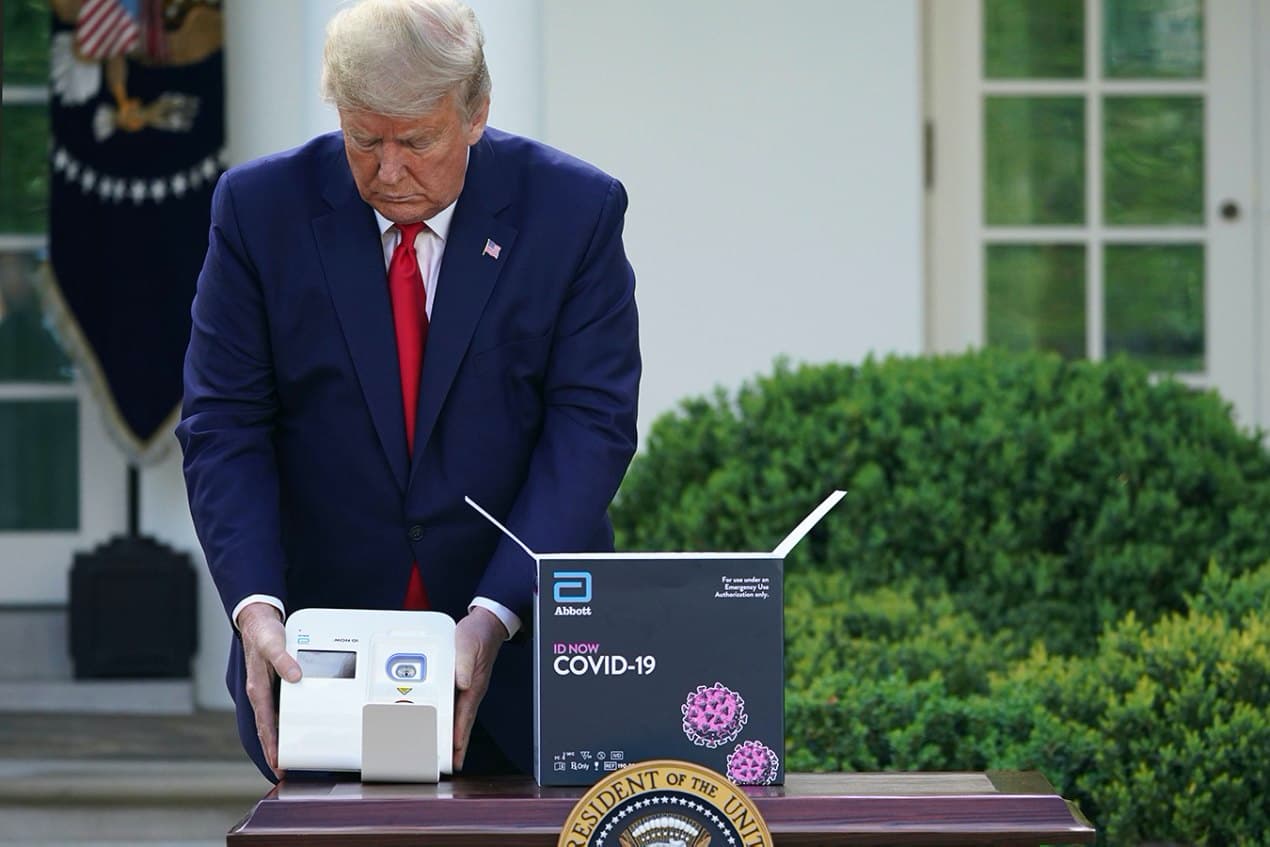 President Donald Trump holds a 5-minute test for COVID-19 from Abbott Laboratories.