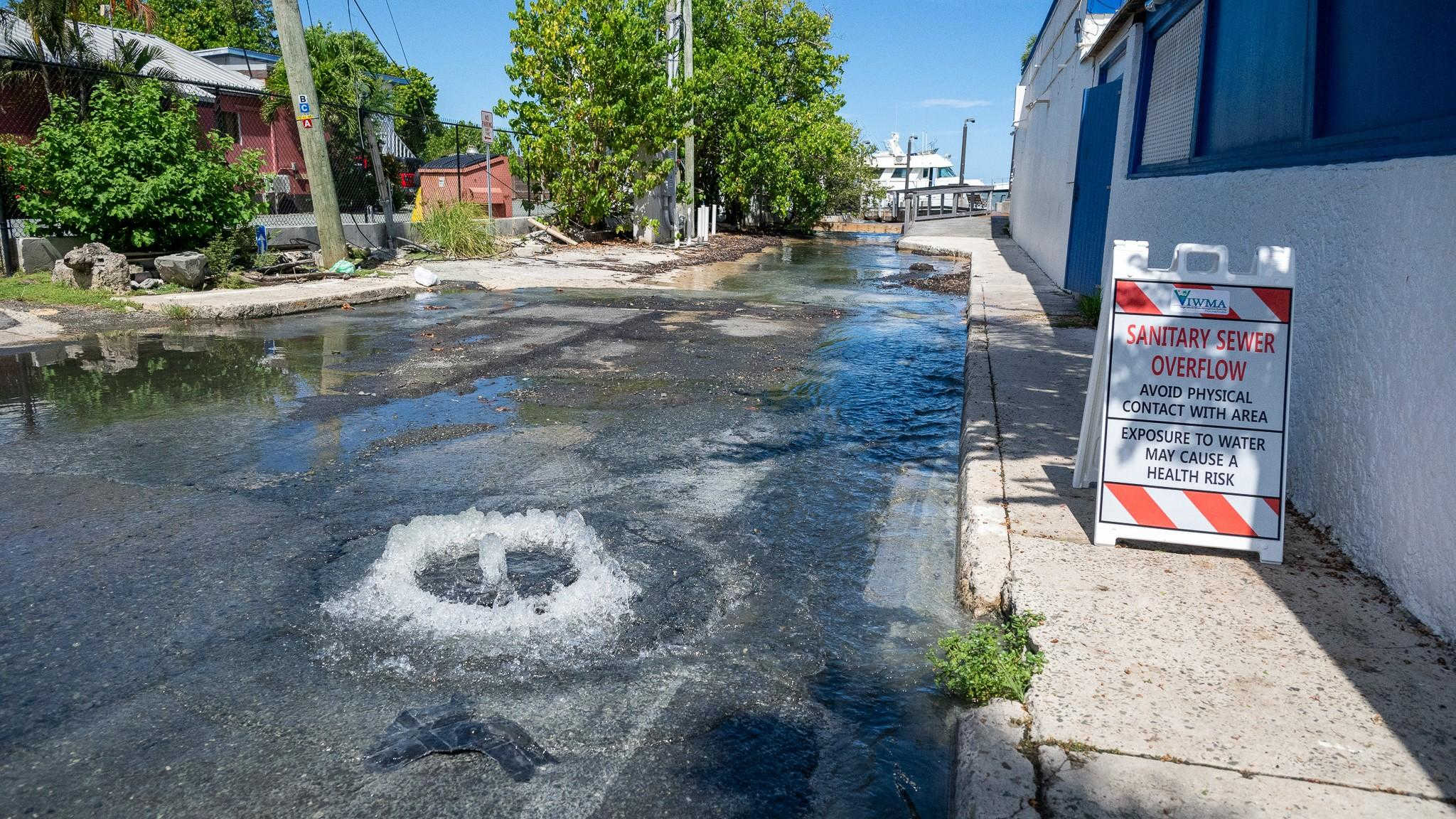 A Waste Management Authority warning sign marks a sewage overflow in Christiansted in October 2024. The agency now proposes relocating the troubled LBJ Pump Station inland to prevent recurring spills.