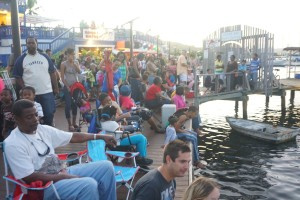 Locals line the Christiansted boardwalk for the Annual Christmas Boat Parade