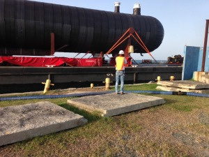 WAPA employee looks on as barge arrives at plant