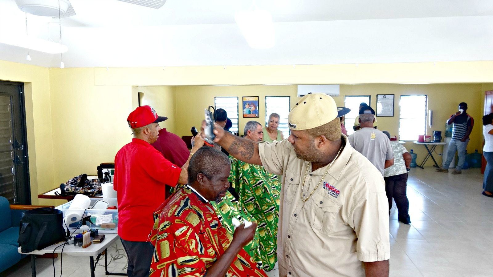 Watch: At Flamboyant Gardens, Karibban Kuts Barbers Put Smile Seniors' Faces