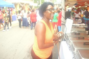 Local awaiting her curry chicken order at the Food, Arts and Craft Fair in Frederiksted.