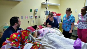 JFL Chief Nursing Officer Justa Encarnacion presents bracelet from LuvKids to mom, Andrea Royer.
