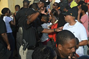 Crucian Carnival Committee President Davidson Charlemagne, right, wearing a white shirt and black hat, across from Fort Christiansvaern, where a fight had just occurred.