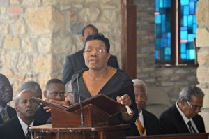 Gwendolyn Hall-Brady, wife of Julio A. Brady, reading her deceased husband's eulogy.
