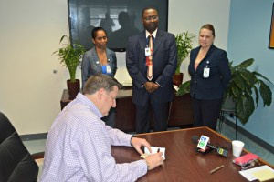David Johnson writes $25,000 check to the Juan F. Luis Hospital during a presentation on Wednesday.