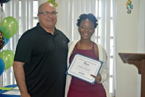 Left to right: Robert Williams, Roger Williams, outgoing vice president of Interstate Realty Management, and UVI freshman Felicia Daniel (Credit: Ernice Gilbert, VIC)