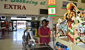 A Plaza Extra East cashier awaits customers.