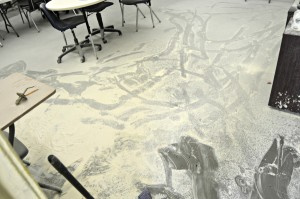 Floor of vandalized classroom, dirtied with fire extinguisher foam.