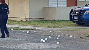 Police place markers where shell casings were discovered.