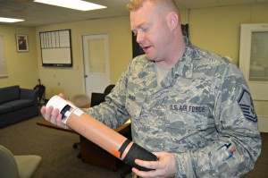 Hurricane Hunters Public Affairs Manager Bryan Lamar holding a dropsonde. The Hunters use the device to collect hurricane data by dropping it into the storm. According to Mr. Lamar, two pages of data is collected every second as the device drops.