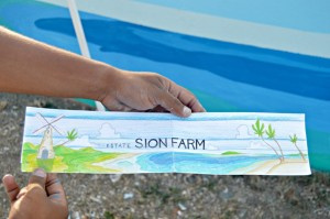 Victor Cepeda holds up a drawing of the Sion Farm mural.