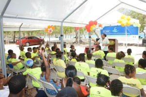 Summer learn-to-swim campers listen to instructor underneath a tent at Magen's Bay.