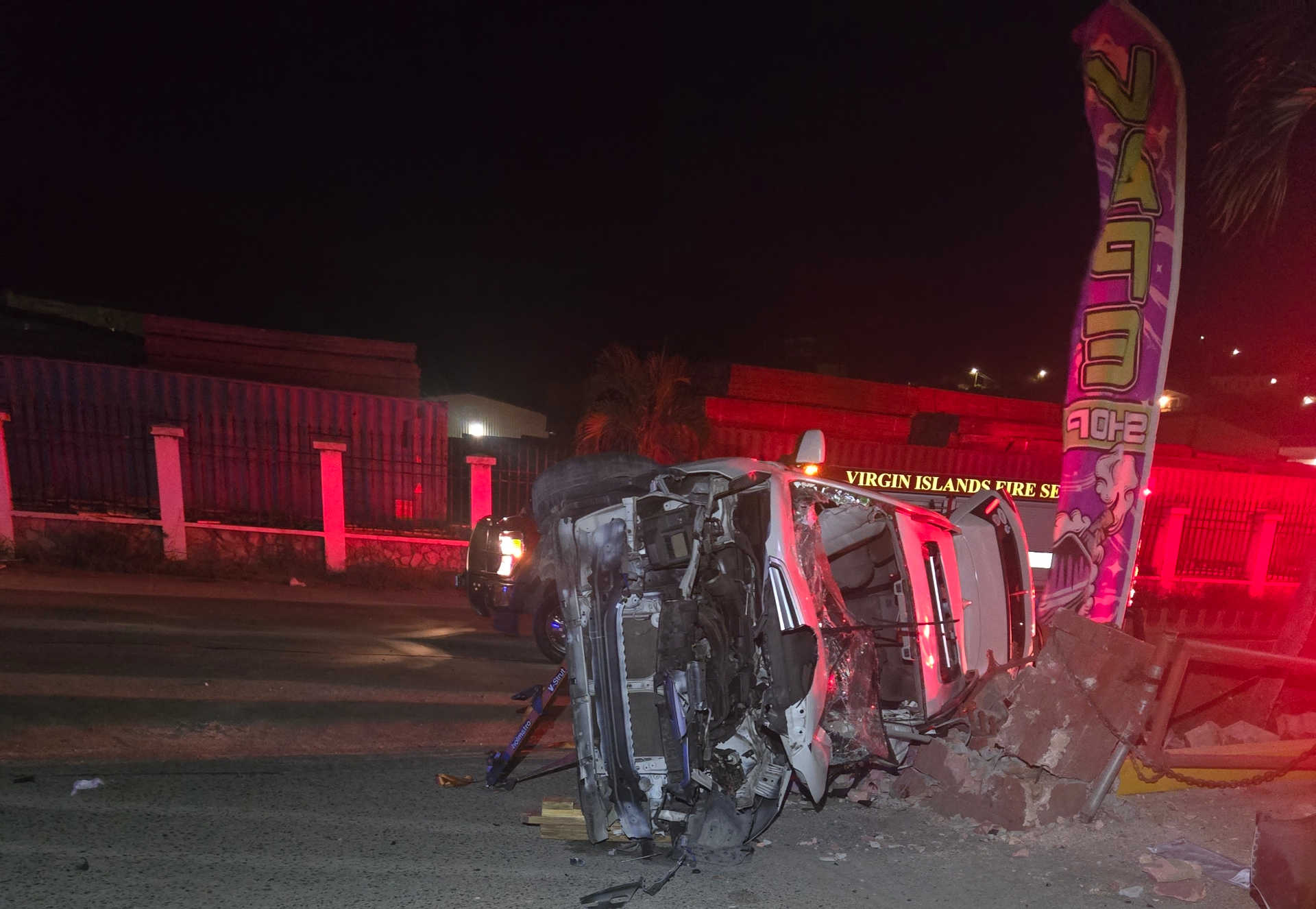A white Subaru Forester rests on its side after crashing into a brick pillar near Gasworks Gas Station on Bovoni Road, where one man died and two women were injured early Sunday.
