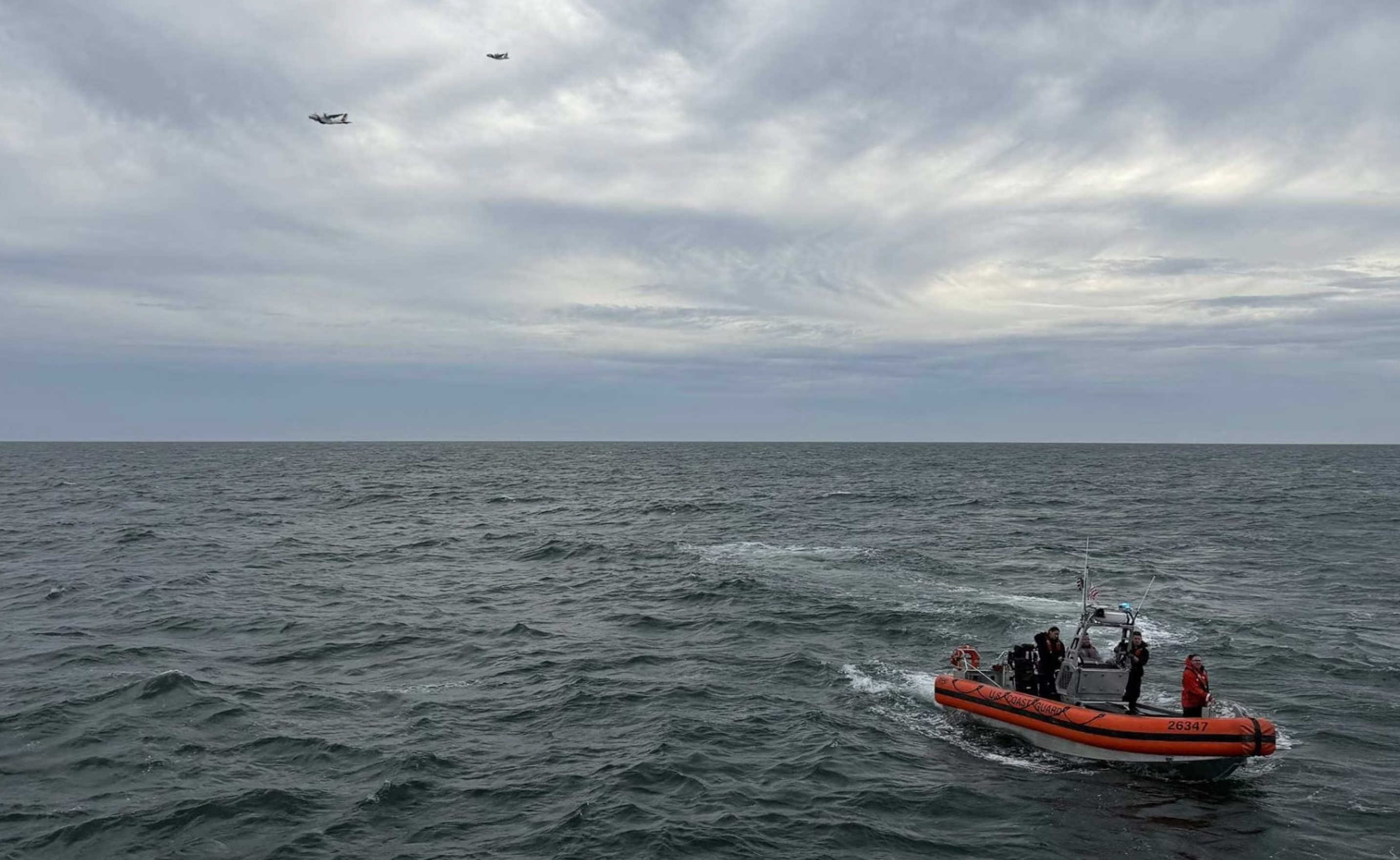 A U.S. Coast Guard search crew operates off Nantucket after debris from the missing Bermuda-to-Boston air ambulance was found, with all six people aboard still unaccounted for.