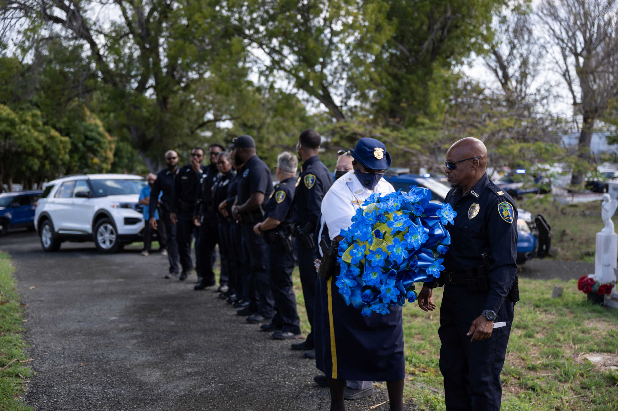 Virgin Islands police officers carry a wreath during a Police Week memorial on St. Croix. The proposed Heroes Act would provide $150,000 in death benefits for eligible officers, as lawmakers debate the exclusion of firefighters.