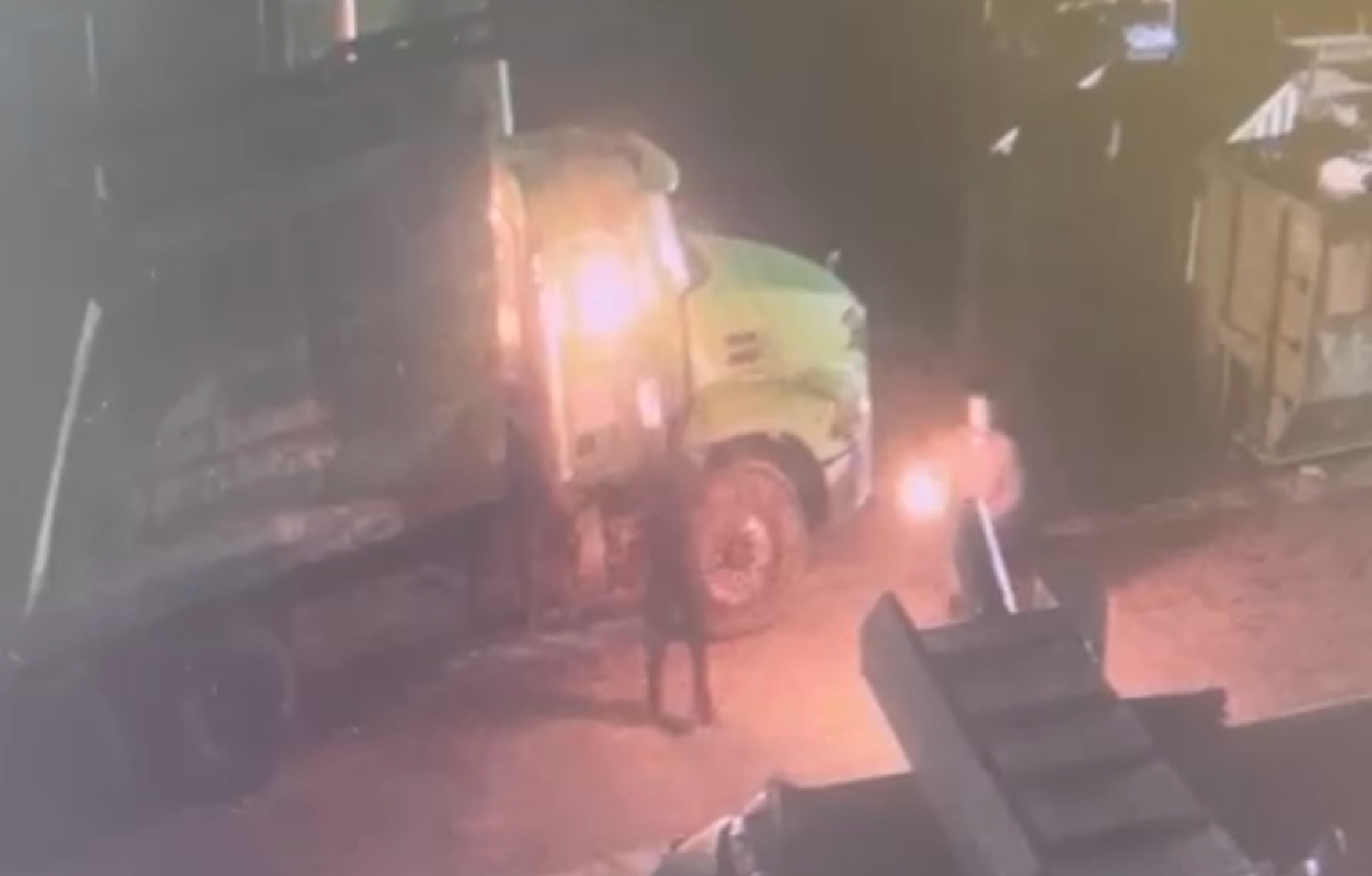 One of two arsonists is seen throwing what appears to be a Molotov cocktail into a truck belonging to Just Right Trucking & Trash Removal LLC.