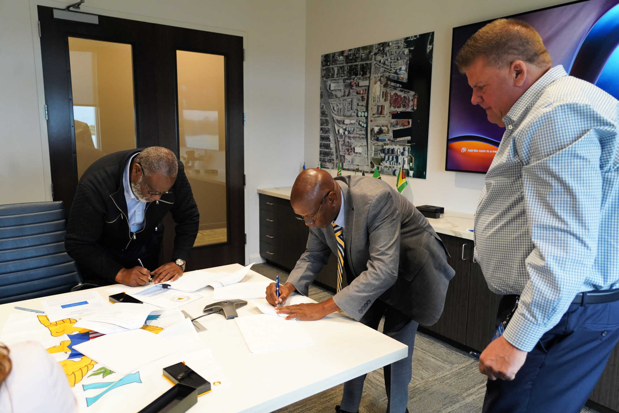 L2: VIPA Attorney Vincent Frazer, VIPA Exec. Dir. Carlton Dowe, and Timothy Martin, Tropical Shipping President.
