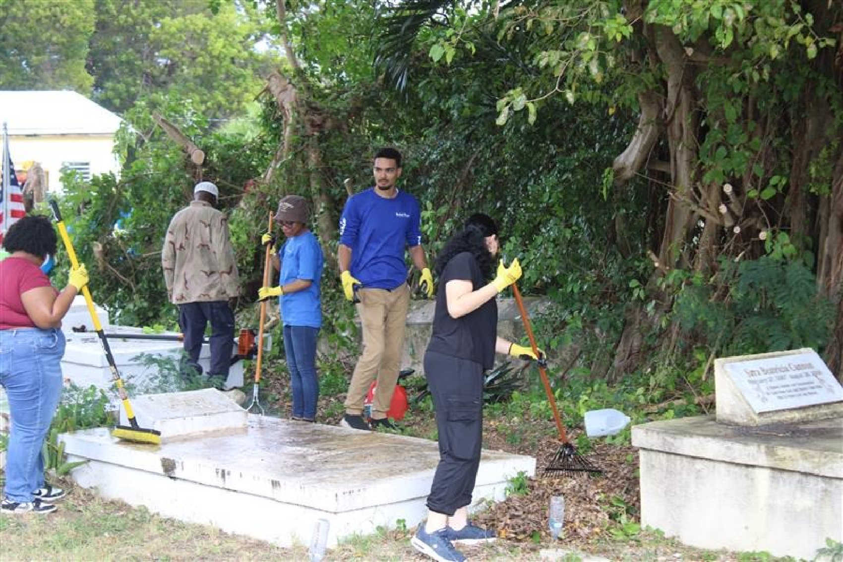 UVI Albert A. Sheen Campus SGA students clear leaves and debris from gravesites during the “Legacy in Bloom” service project at the historic Frederiksted Cemetery in St. Croix.